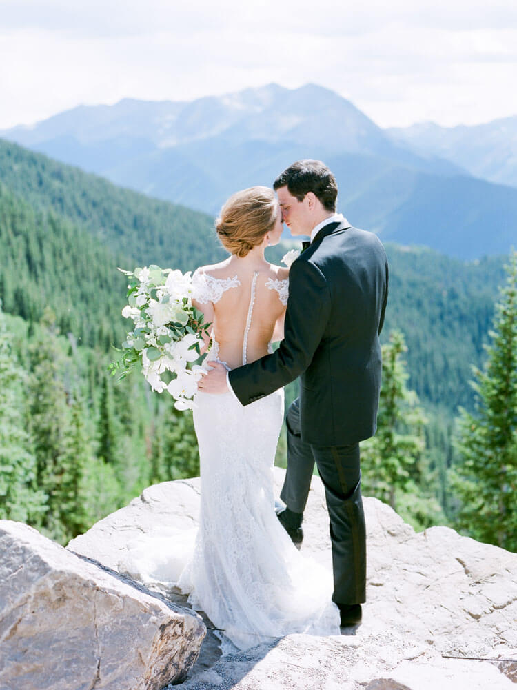 Aspen Wedding bride and groom embracing on Aspen Mountain photography by Tara Marolda